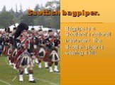 Scottish bagpiper. Bagpipe is a Scotland’s national instrument. The Scottish piper is wearing a kilt.