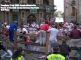 Pamplona, 7 July 2005. People climb to the fences as the bulls run by and cross the Town Hall Plaza